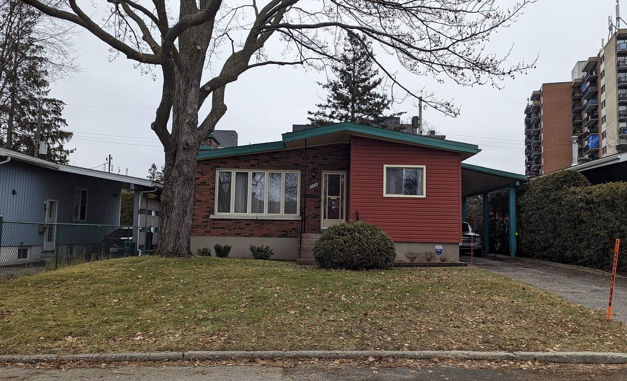 Brick bungalow rental property in Ottawa in winter, with snow on the ground and roof